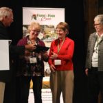 Volunteers with Durham Food Connections accept their award from Bruce Christie.
