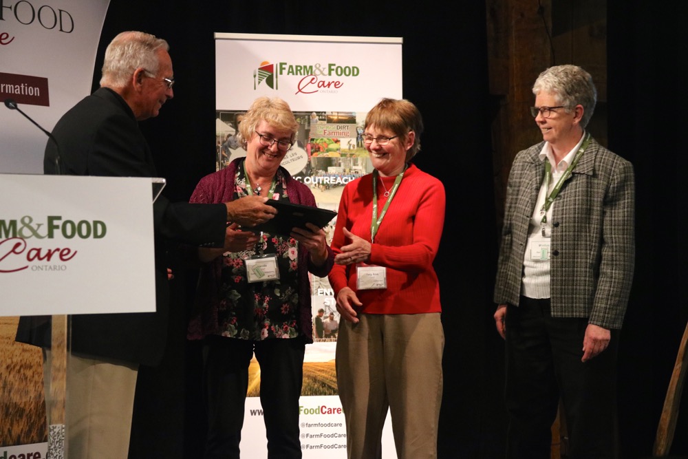 Volunteers with Durham Food Connections accept their award from Bruce Christie.