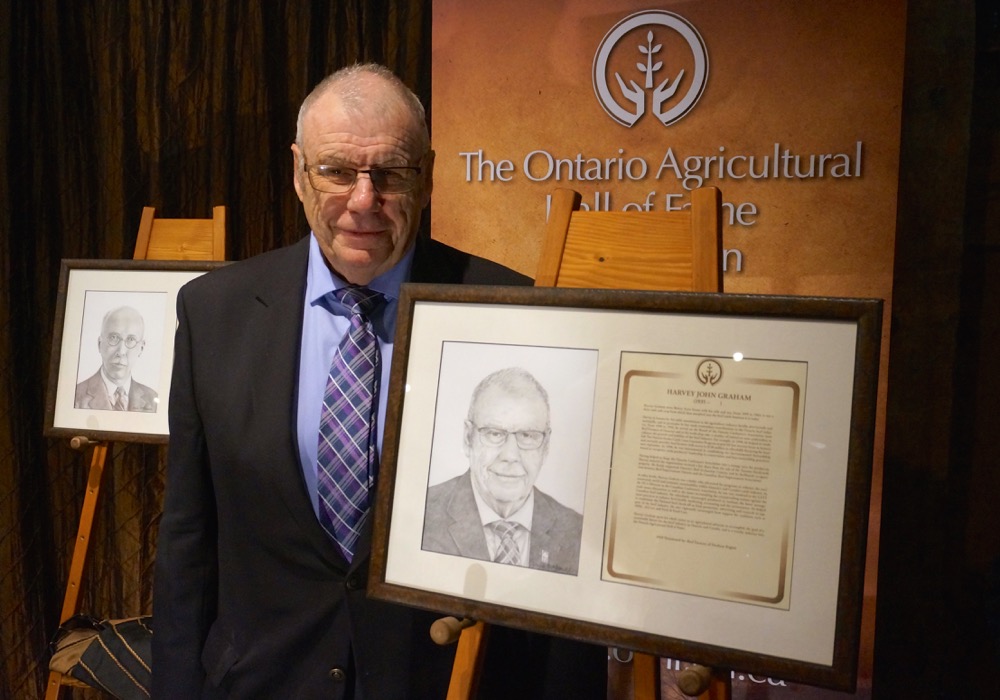 Inductee Harvey Graham with his portrait.