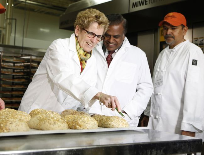 Ontario Premier/Agriculture Minister Kathleen Wynne, shown here at Scarborough’s Stonemill Bakehouse in April, returns to Queen’s Park with a majority mandate after Thursday’s election. (Premier.gov.on.ca via Flickr)
