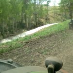 A farmer seeding east of Olds, Alta. on May 23 snapped a photo from the cab showing what was described as a last ribbon of snow at the field’s edge. Central and northern Alberta are expected to have a drier bias heading into August and September. (Submitted photo)