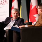 Prime Minister Stephen Harper, shown here with Saskatchewan Association of Rural Municipalities (SARM) president Ray Orb in Saskatoon on Thursday, said Canada’s big two railways can’t be allowed to define “satisfactory” in terms of grain handling service. (PMO photo by Jill Thompson)