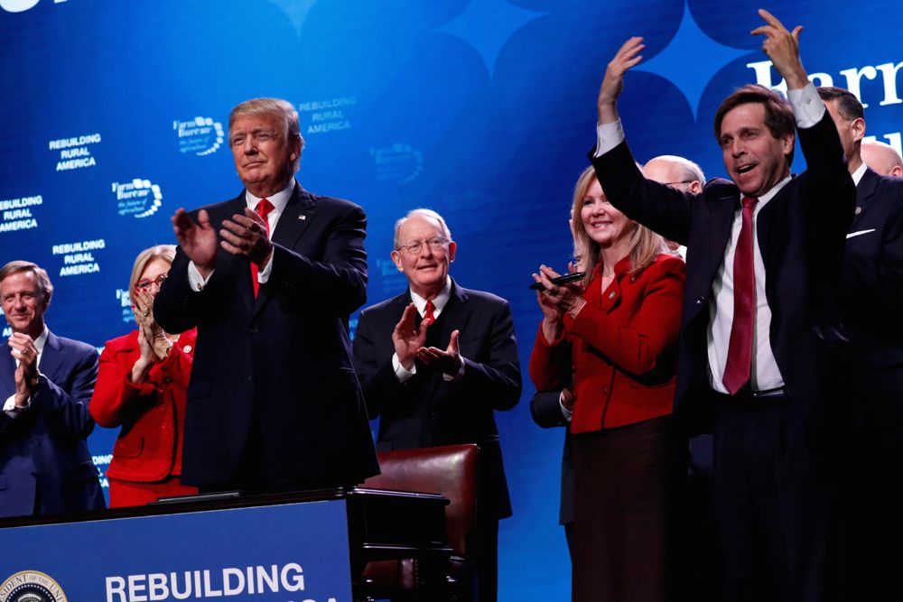 U.S. President Donald Trump celebrates after signing a pair of documents meant to promote rural internet access, after his remarks to the American Farm Bureau Federation convention in Nashville on Jan. 8. Photo: Reuters/Jonathan Ernst
