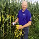 Devin Homick checked the yield in this field of corn near Thorndale during the Great Lakes Grain crop yield tour.