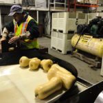 A worker at Connery’s Riverdale Farms packages squash at warehouse on the farm located near Portage la Prairie, Man.
