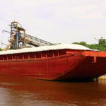 A barge loads on the Mississippi River. American soybeans aren’t moving to China, even though they are price competitive with Brazil.