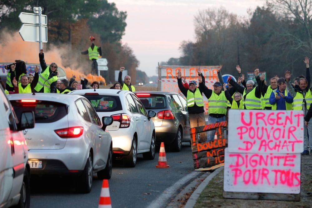 Protesters wearing yellow vests, the symbol of a French drivers’ protest against higher diesel prices, occupy a roundabout in Cissac-Medoc, France on Wednesday. The slogan in pink reads “Urgent, purchase power, dignity for all.” (Photo: Reuters/Regis Duvignau)
