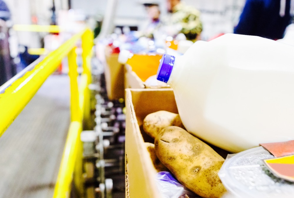 Healthy donated groceries in boxes at food bank warehouse