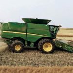 Josh Lade drives his John Deere S680 combine with the Seed Terminator installed near Osler, Sask.