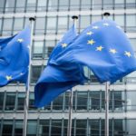 Flags in front of the European Commission headquarters in Brussels. (Inakiantonana/E+/Getty Images)