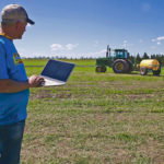 Brian Tischler demonstrates how he’s able to drive his tractor autonomously using software on a laptop.