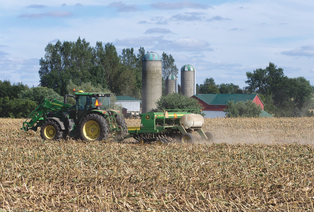 Getting out of the tractor cab to check soil conditions is important to getting  the crop off to a strong start.