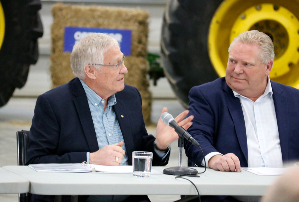 Ernie Hardeman, left, Ontario’s minister of Agriculture Food and Rural Affairs talks to Premier Doug Ford during a visit to a Woodstock-area farm.