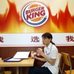 A customer dines at a Burger King outlet in Shanghai on June 27, 2005. (File photo: Reuters/Ming Ming)