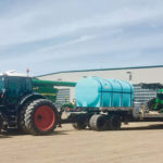 The fifth-wheel receiver installed on this trailer enables a producer to drive a sprayer onto the trailer and immediately secure it without chaining it down.