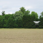 A small drone scouts the corn plant population.