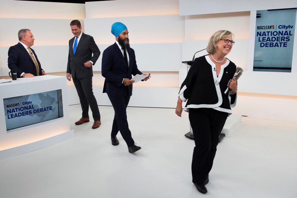 Green Party leader Elizabeth May walks off the set past moderator Paul Wells (l), Conservative leader Andrew Scheer and New Democratic Party (NDP) leader Jagmeet Singh after the Maclean’s/Citytv leaders’ debate in Toronto on Sept. 12, 2019. (Pool photo: Frank Gunn via Reuters)
