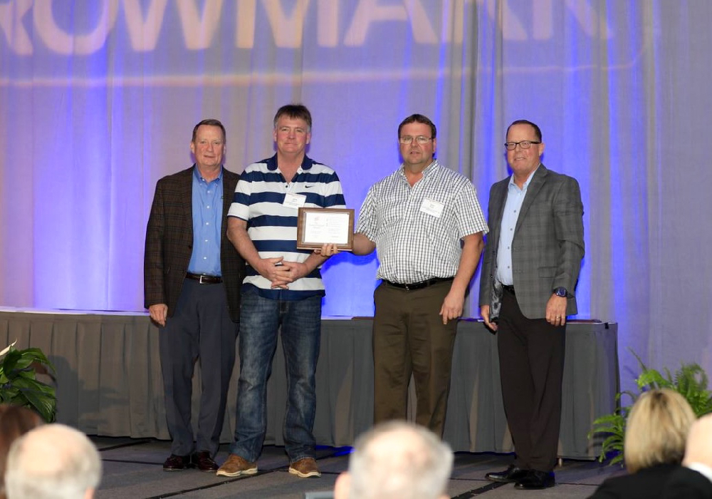 Brent Ericson, GROWMARK senior VP of Member Business, left, and Mike Turner, VP of Midwest Operations, present the management excellence award to Lucknow District Co-operative President David Gibson and General Manager Allan Scott.