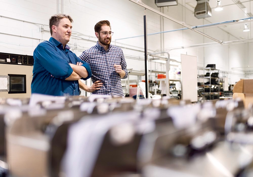 Michael Taschuk, chief technology officer and founder of G2V, with Ryan Tucker, chief executive officer, talk at the G2V production facility. 
