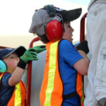 Safety is key for young children around a farm. The Maw family has had seat belts installed in all tractors if they didn’t come with one. Their kids wear safety vests, ear protection, workboots/shoes and gloves for their protection while helping with farming.