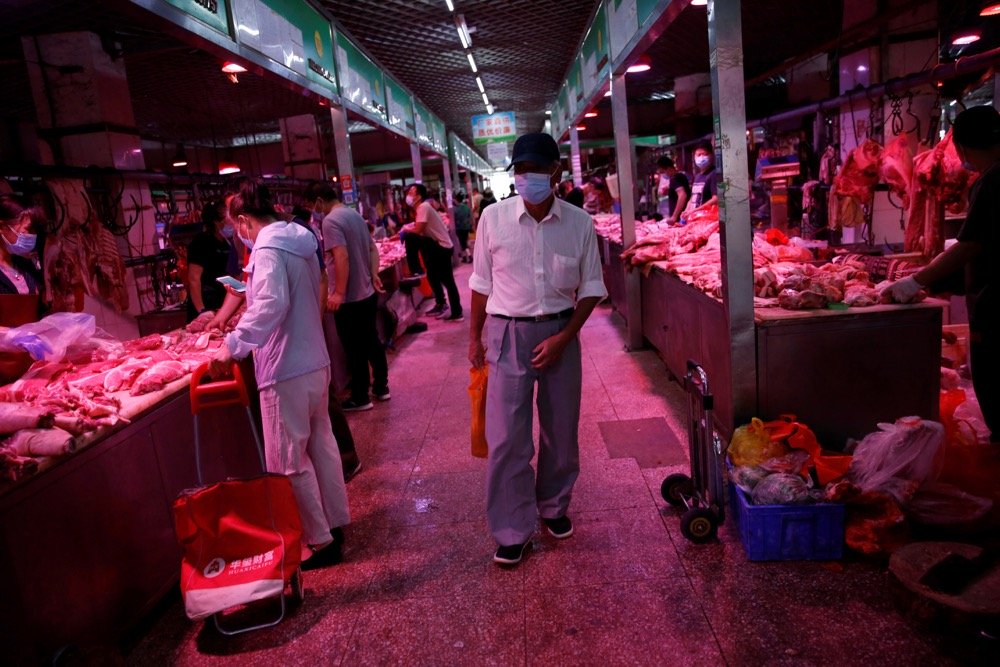 A customer shops at a pork meat hall at the Yuegezhuang wholesale market in Beijing on June 17, 2020. (Photo: Reuters/Tingshu Wang)
