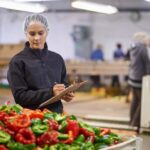 File photo of a quality control check on fresh peppers in a Canadian vegetable packing plant. (Jeffbergen/E+Getty Images)