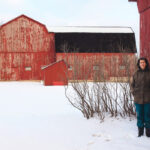 Marsha Rempel, with some of the barns on her farm.