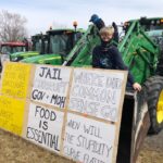 Austin Kulielka,7, perches on his father’s tractor during the Ontario’s Garden Farmer tractor protest in Simcoe.