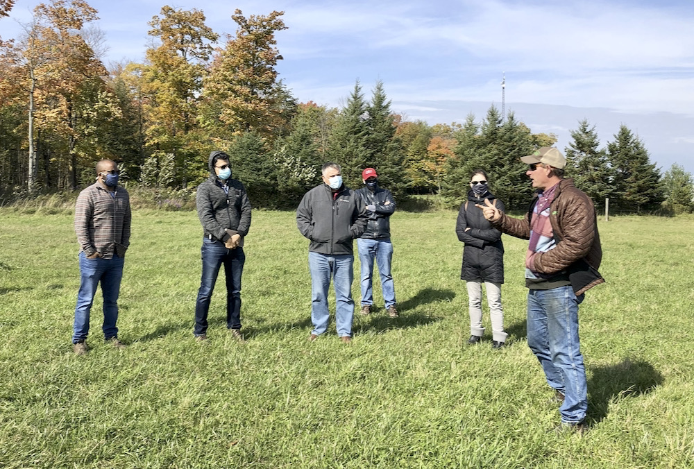 Mike Swidersky, sheep and beef farmer in Amaranth, right, answers questions from mentees on a farm visit last fall.