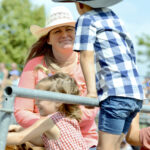 Anna Dale chats with Wim Rosegaar, 6, and his sister Berkine,4, before the Orangeville rodeo’s ladies barrel race Sunday. It was the Rosegaar’s first rodeo.