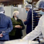 Lisa Thompson, Ontario Minister of Agriculture, Food and Rural Affairs, centre, listens as Vidhya Food Inc. president Vipul Patel, right, explains the packaging process during a tour of the Mississauga food manufacturing facility Oct. 21.