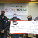 John Nooyen (left), AGRIS Co-operative board President and Jim Anderson (middle), AGRIS ownership committee chair, presents a donation to Harvest Hands. Jim and Jacintha Collins, founders, (right), accepts the donation on behalf of Harvest Hands. The $15,000 donation will be used to serve families and agencies in the communities surrounding AGRIS Co-operative.