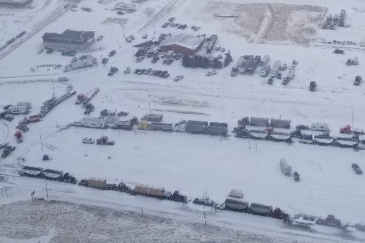 A supplied aerial photo of vehicles blocking through traffic on Feb. 1, 2022 at the Canada-U.S. border crossing between Coutts, Alta. and Sweet Grass, Montana. (Photo courtesy Alberta RCMP)
