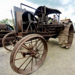 Gordon Brindley, known to many as Harry, sits on an All Work steel wheel, cross engine tractor over 100 years old. Brindley purchased it in Eastern Ontario, and while it needs some mild restoration, it was the rarest iron in the antique tractor auction and one of his favourite pieces.