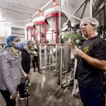 Jason Persall, owner of Pristine Gourmet and cash crop farmer, explains to a Farm and Food Care tour how black oil sunflowers are cold pressed into highly sought-after sunflower oil at his Norfolk County operation.