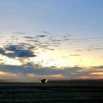 A combine in the Interlake runs against the setting sun on Nov. 1, 2022, in an effort to wrap up harvest. Photo: Greg Berg
