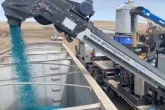 A G-Mac’s custom seed treatment unit loads a truck with treated peas in a 2020 video screengrab. (G-Mac’s AgTeam via YouTube)