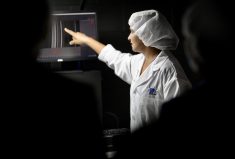 A P&P Optica employee shows how the company’s smart visioning technology can help improve food safety at a recent open house.