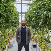 Dr. Jason Lanoue, Post-Doctoral Researcher at Agriculture and Agri-Food Canada, stands in one of the greenhouses used for production and physiology research at the Harrow Research and Development Centre.