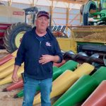 Henry Denotter stands in front of the combine header he and his son Jeremy built to suit their 20-inch row cropping system.