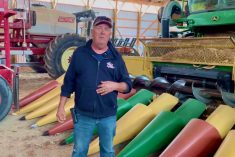 Henry Denotter stands in front of the combine header he and his son Jeremy built to suit their 20-inch row cropping system.