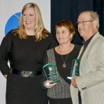 Tara Terpstra, an Ontario Pork board member, left, presents Sharon and Ron Douglas, far right, of Huron County, with the 2023 Ontario Pork Recognition Award during the OP annual general meeting.