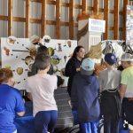 At the Farming Numbers station, children learned that more than just food comes from agriculture. For example, hides from cows are used to make leather, and sugars from corn can be used to produce fuel and sweeten beverages.