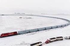 Aerial view of a loop track featuring a train of CPKC’s newer “high-efficiency” grain hopper cars, at a G3 elevator near Moose Jaw, Sask. in December 2018. (CPR.ca)