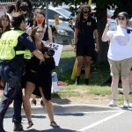 Sabrina Desgagne, New Wave Activist, is removed from the entrance of Sofina Fearmans Pork Inc. by Halton Regional Police Service Const. Barnes as she attempts to step in front of a moving livestock transport as it makes its way into the processing plant Aug. 20.