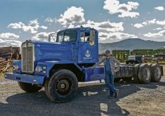 Chace Barber, CEO of Edison Motors, stands beside the company’s first concept truck, a 1962 LW900 Kenworth converted to diesel-electric hybrid drive.