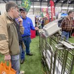 Bert Tichelaar, owner of Ayrquip Ltd., right, discusses how pig sorter software can be mounted on an existing sorter with Peter Mettler, left, who runs a 300-sow farrow-to-finish pork operation near Wallenstein.