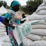 FILE PHOTO. A woman receives a bag of food from the government during the distribution of food items by the government to cushion the high cost of living in Abuja, Nigeria, September 20, 2022. REUTERS/Afolabi Sotunde