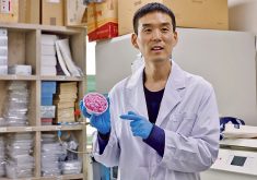 Professor Jinkee Hong, who led the work to develop hybrid beef rice using cow muscle and fat stem cells, holds a bowl of the finished product in a laboratory at Yonsei University in Seoul, South Korea.