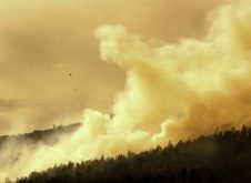 A helicopter dumps water on a forest fire in the Okanagan Valley, British Columbia.  Photo: Thinkstock
